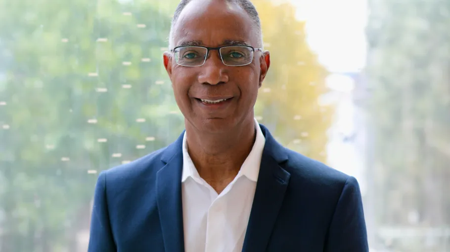 Headshot of Dr. Gervan Fearon in a navy blazer and white shirt