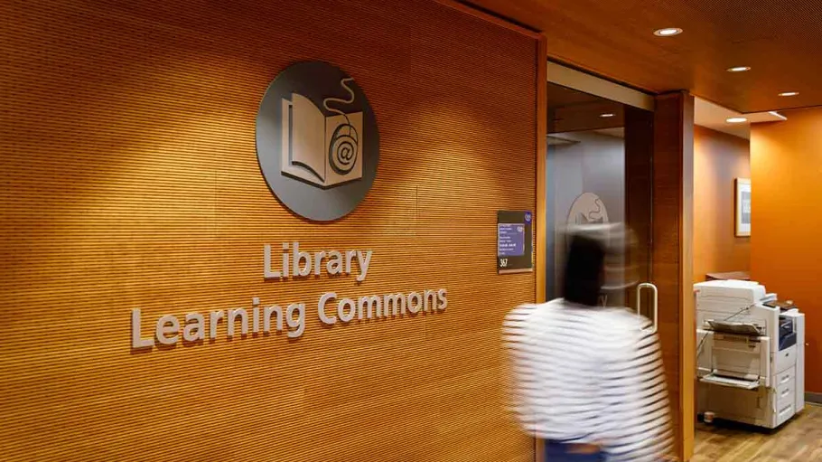 Student walking past Library entrance