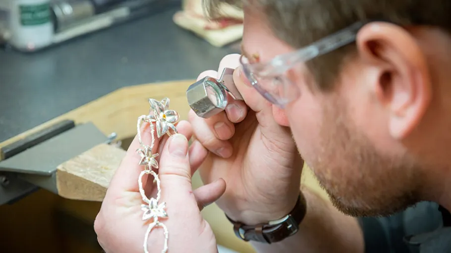 jeweller checking a necklace