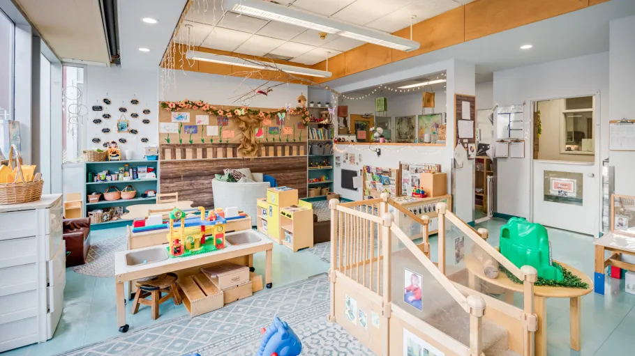 Interior view of one of the Casa Loma child care centre rooms with activity areas and toys.