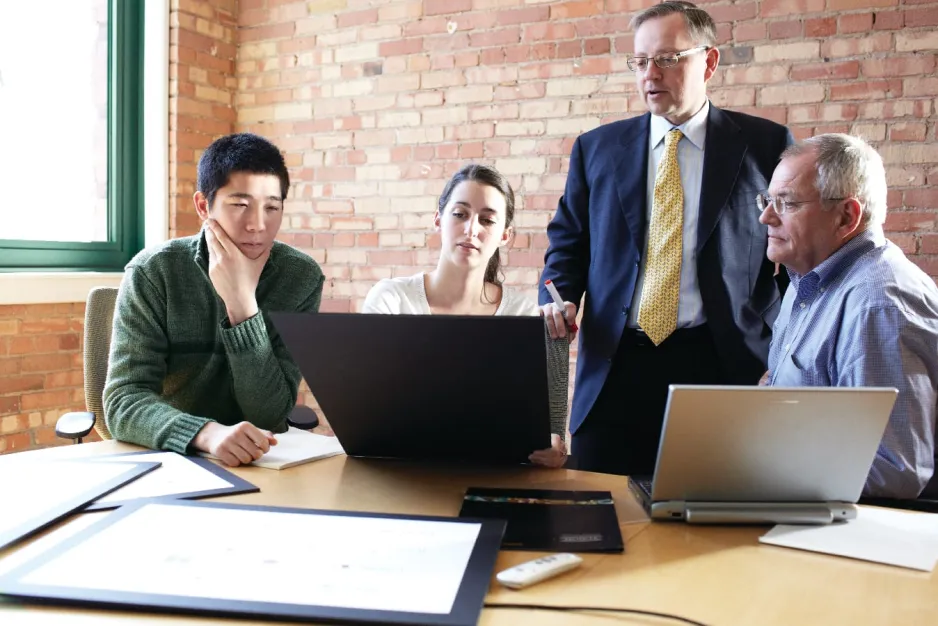 Business students meeting in the workplace with their employer.