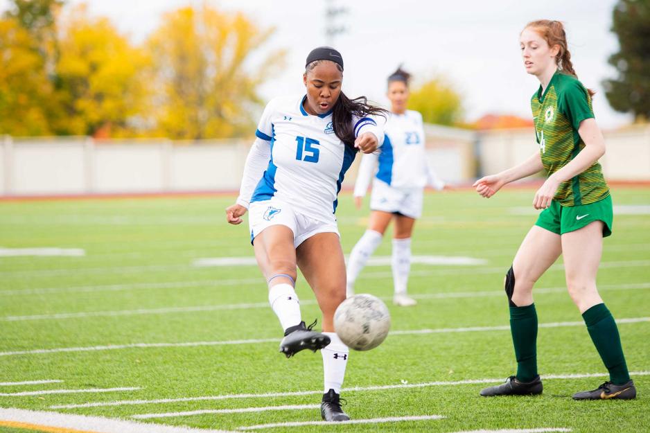 Brianna Samuels McLaughlin on the soccer pitch with opposing player