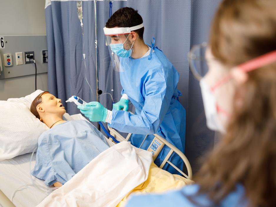 Nursing students working with a mannequin