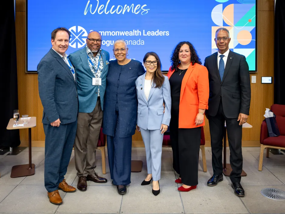 Panelists at the 2025 Canadian-Caribbean Leaders Dialogue pose together in a brightly lit room