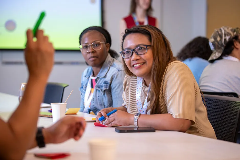 2 employees at a table support staff day 2025