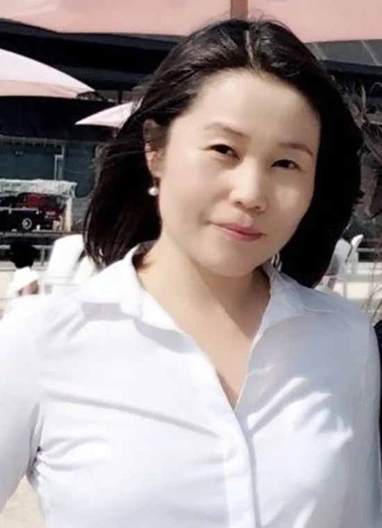 A woman with black hair and a white shirt