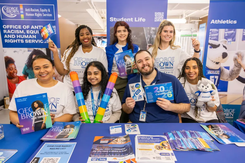 Student success teams hold up materials at the learning support fair