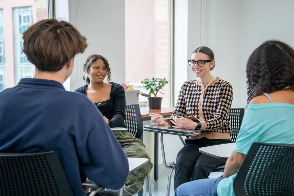 George Brown Polytechnic Child and Youth Care students participating in a small group discussion with an instructor holding a clipboard.