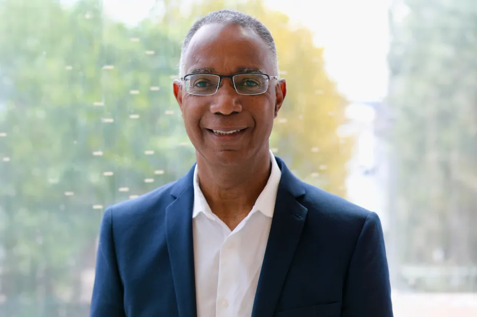 Headshot of Dr. Gervan Fearon in a navy blazer and white shirt