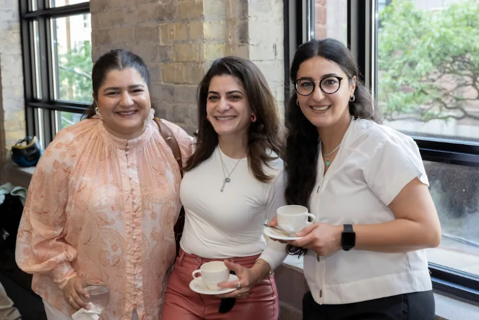 Three ReNEW program participants smile together during a George Brown Polytechnic event.