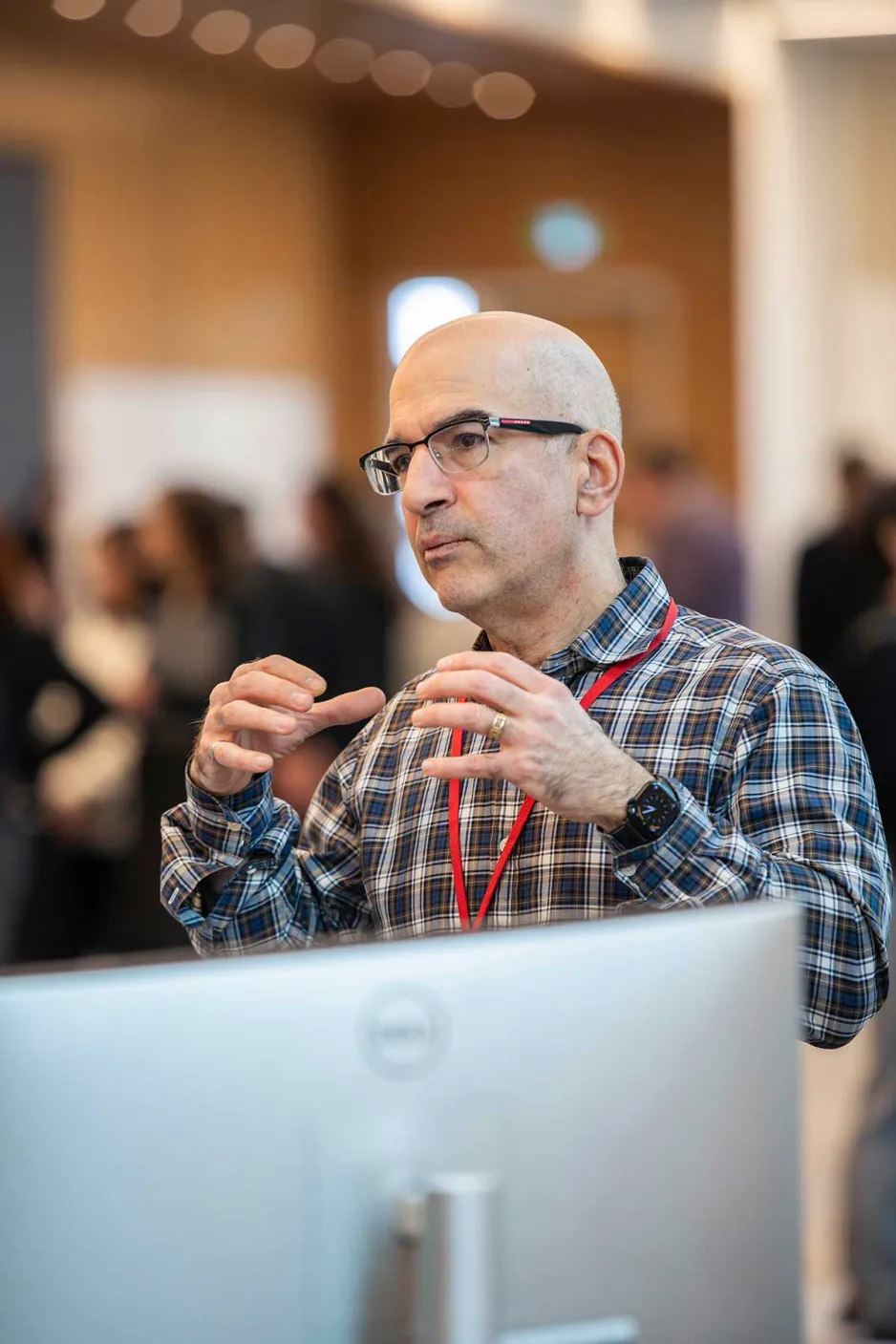 Man explaining something in front of computer