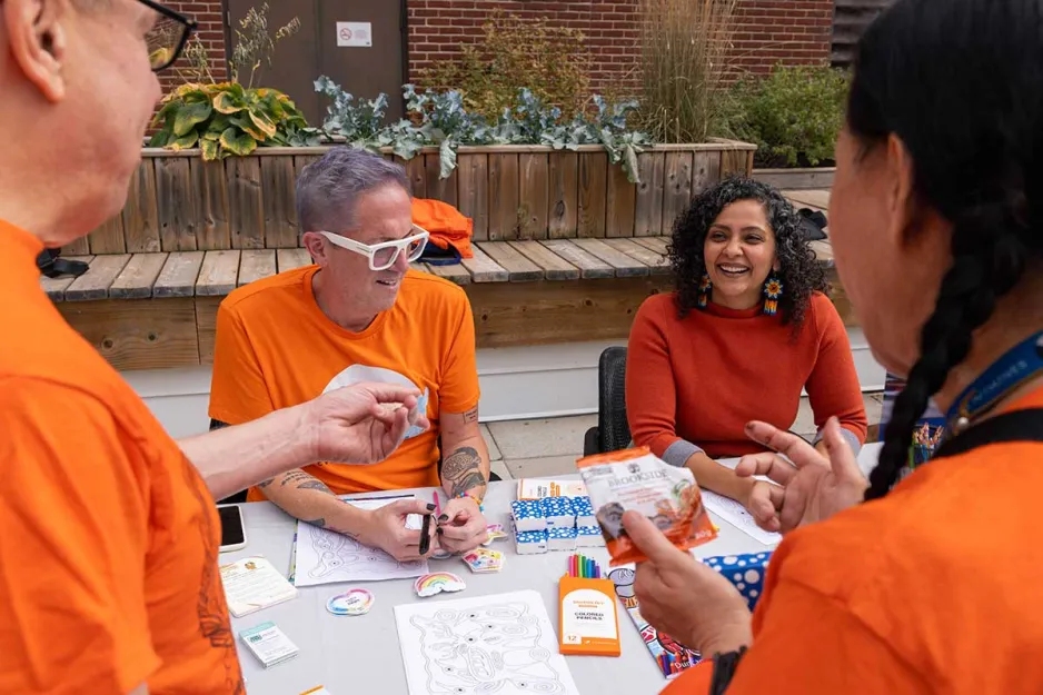 People at an Orange Shirt Day table