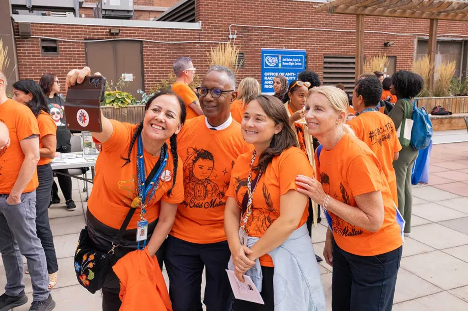 People gathered at an Orange Shirt Day event