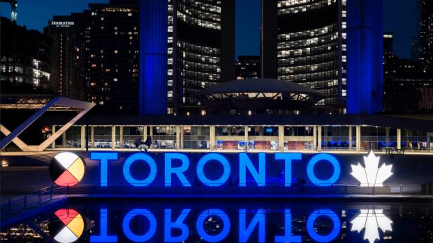Toronto Sign lit blue at night, from @TorontosMayor on Twitter