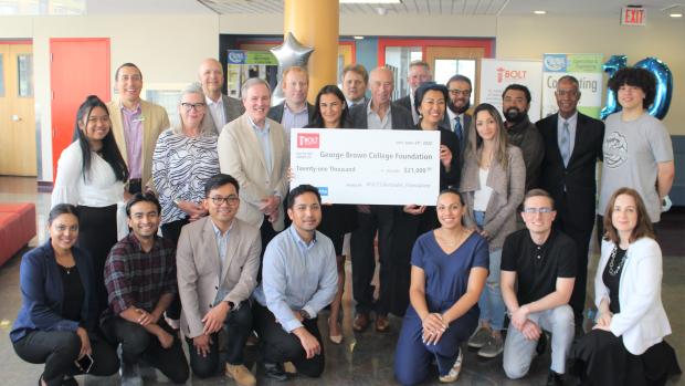 BOLT and GBC members gather around a large cheque