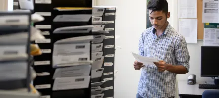Student reading an information sheet
