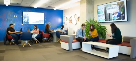 The lounge and the Student Entrepreneur co-working space at Start GBC's office, occupied with students working on their laptops or tablets. 