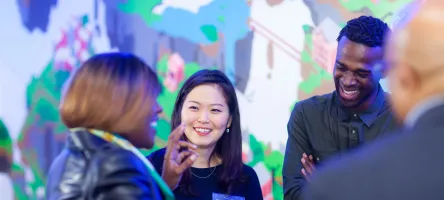 3 people chatting at Blackburn conference centre opening celebration