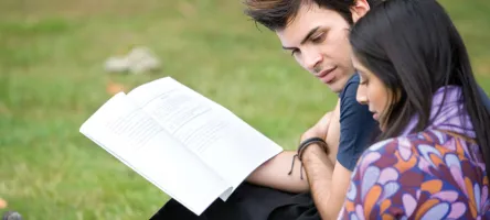 Man and woman looking at a textbook