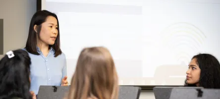 A librarian lecturing students in the computer lab at the Waterfront Library.