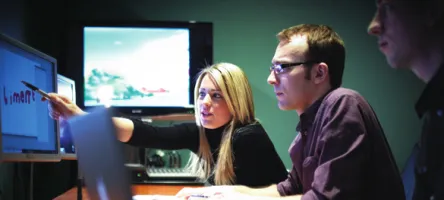 Students collaborating around a computer