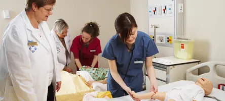 Student nurse attending to a mannequin patient