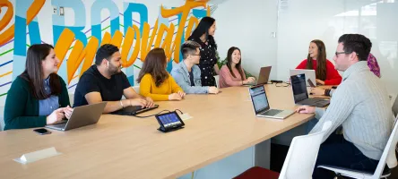 Students sitting at boardroom table