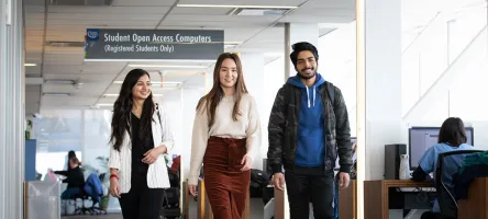 3 students walking through Waterfront Campus library
