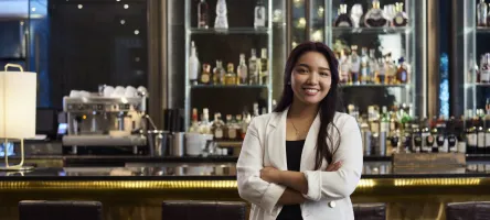 Woman standing in from of bar