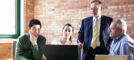 Business students meeting in the workplace with their employer.