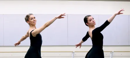 Female Performing Arts students pose in a dance studio.