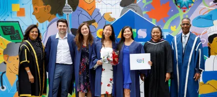 Graduates posing with GBC president after convocation ceremony.