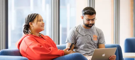 2 students sitting in a lounge area at St. James Campus