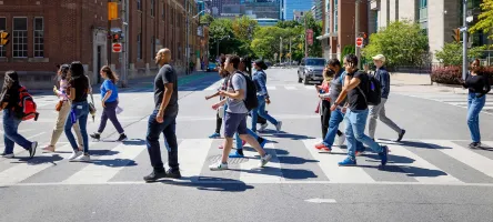Students on a tour walking across Adelaide Street at the crosswalk.