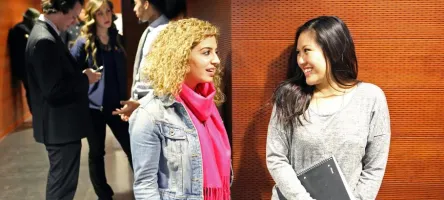 Two students facing each other engaged in conversation