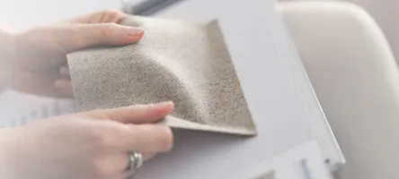 A woman examining a fabric swatch