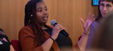 A woman is speaking to an unseen audience
