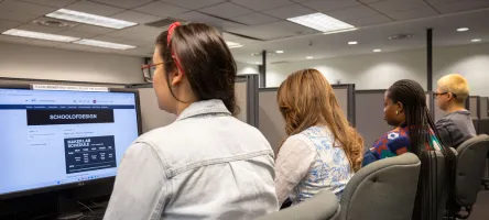 Test takers complete exams at individual computer stations in a George Brown Polytechnic Assessment Centre.