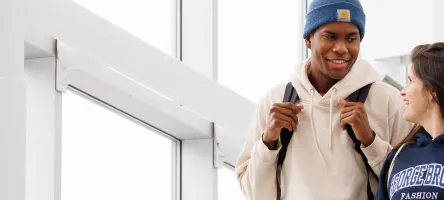 banner image, two students talking 